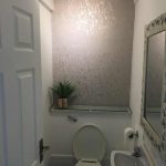 A small cloakroom with a toilet and sink.