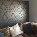 Lounge with bold grey patterned wallpaper.