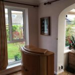 Corner of lounge with archway leading to conservatory