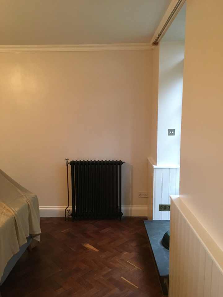 Lounge with black victorian style radiator.