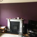 Victorian lounge showing fireplace wall painted a deep purple